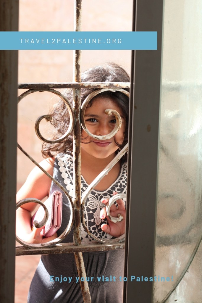 A Palestinian child looking through a window