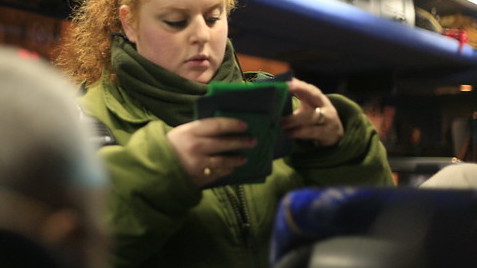A border officer checking ID cards 